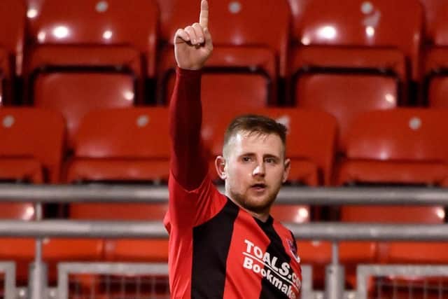 Crusaders striker David Cushley celebrates giving his side the lead against Institute.