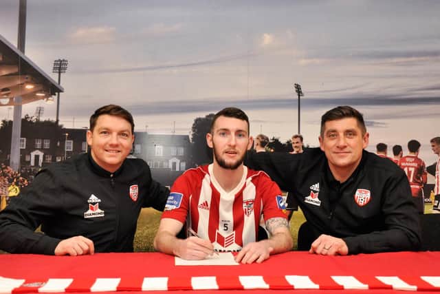 Derry City assistant, Kevin Deery and manager, Declan Devine pictured with Jamie McDonagh who agreed to sign  a new contract.