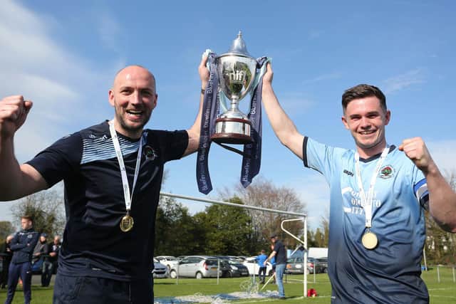 Institute manager Paddy McLaughlin and club captain Michael McCrudden with the Bluefin Championship trophy in 2018.
