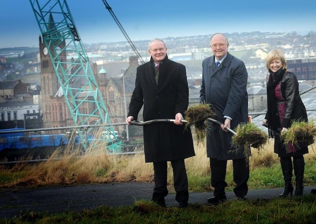 The Deputy First Minister, Martin McGuinness, MLA, Sir Roy McNulty, chairman, Ilex, and Aideen McGinley, Chief Executive, cutting the first sod on the Peace Bridge at Ebrington in 2010.