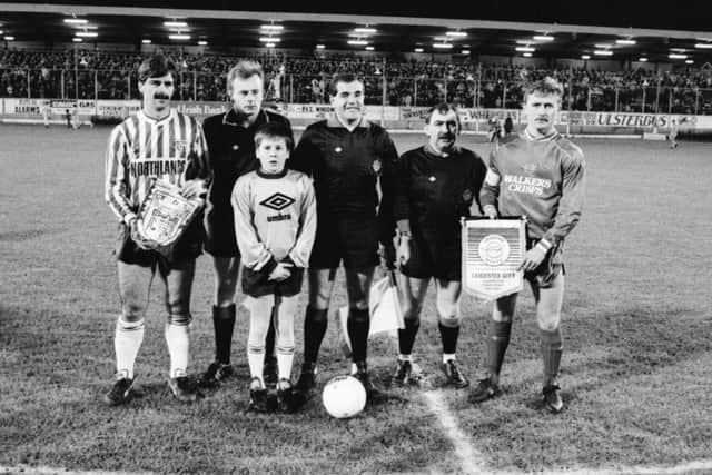 Derry City captain, Felix Healy and Leicester City captain, Ally Mauchlen pictured with the match officials and mascot, Sean Glackin ahead of kick-off.