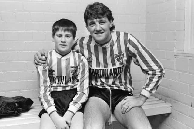 Manchester United defender and current Newcastle United man ager, Steve Bruce pictured with mascot, Sean Glackin before the match.