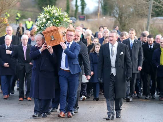 Mourners walk the final few steps carrying the coffin of Seamus Mallon into St James of Jerusalem Church in Mullaghbrack, Co. Armagh.