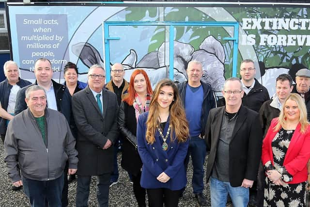 Peter McDonald, Leafair Community Association with the Housing Executive's Eddie Doherty Area Manager and Isobel Kelly Patch Manager, Cara Hunter Deputy Mayor of Derry City and Strabane District Council, Eddie Breslin Housing Executive Good Relations Officer, Councillor Sandra Duffy and Ciara Ferguson, Greater Shantallow Partnership Manager with attendees at the Leafair Mens Shed building opening and reimaging project mural unveiling.