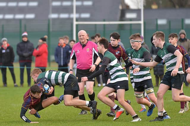 Campbell College players swarm around Foyle College captain Finn Curtis during the Medallion Shield tie on Saturday. DER0520GS - 004
