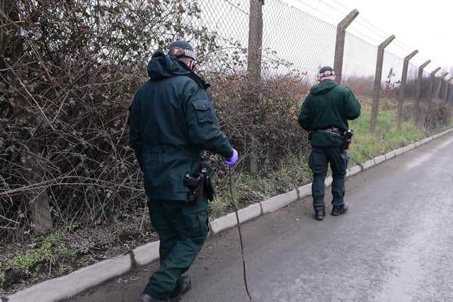 PSNI officers search for evidence close to where the explosive device was discovered. (Photo: Pacemaker)