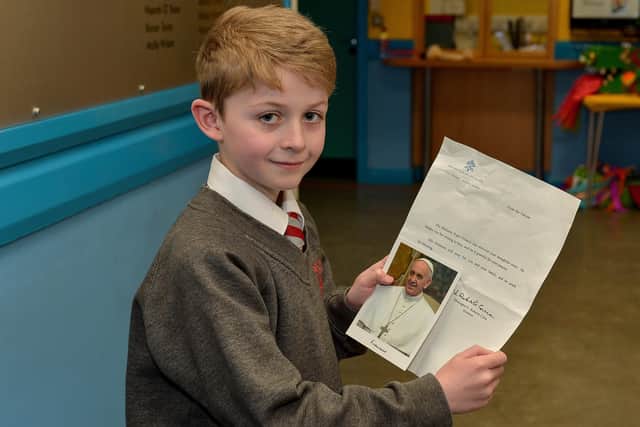 Holy Family Primary School P5 pupil Ruben O’Doherty, aged 8, pictured with the letter and photograph of His Holiness Pope Francis I he received from the Vatican. DER0720GS - 004