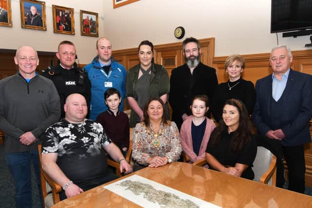 The Mayor, Councillor Michaela Boyle, pictured when she hosted a reception in the Guildhall on Saturday for Jimmy Murray, seated left, from Dunloy, whose bike was damaged during an attack in the city last month. Included are Orlaith Gibben, seated, who set up a Go Fund Me appeal to repair Jimmy's bike, and from left, Dermot Crossan, Inner City Initiative, Constable Chris White, Niall Doran, Inner City Initiative, Logan Sheriff, Councillor Rachael Ferguson, Alex Sheriff, Aria Sheriff, Bernie Gibben, and Councillor Raymond Barr. DER0820-101KM