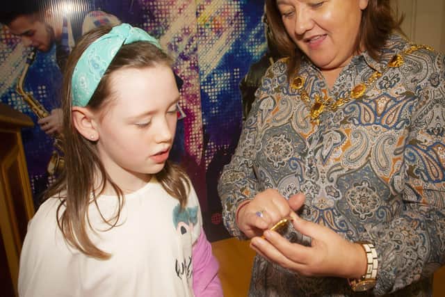 The Mayor of Derry City and Strabane District Council, Michaela Boyle explaining the Mayoral Chain of Office to one of the youngsters at Wednesdayâ€TMs Mid-Term Art Camp at Studio 2.