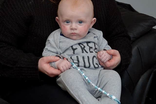 Bronagh Rogan and her four-month-old baby Finn pictured in their Gallaigh Park Home.  Bronagh’s blue bin was set on fire outside her front door on Friday night last by a group of young people. DER0920GS - 018