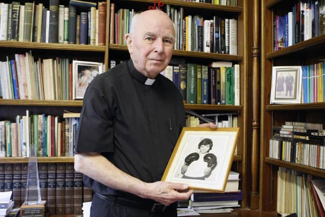 The late Bishop Edward Daly holds a portrait of Jackie Duddy who was killed on Bloody Sunday. (Niall Carson/PA)