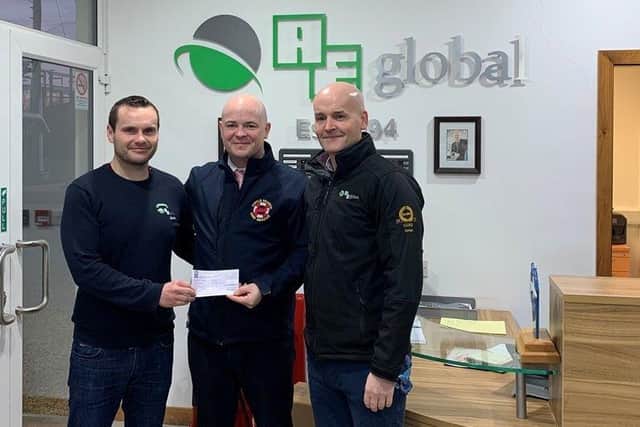 Neil accepting a donation from AE Global recently on behalf of Foyle Search and Rescue