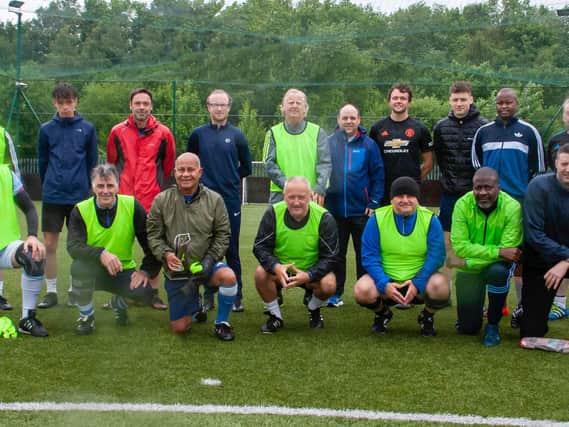 'Wee' Joe Doherty, third from right in the front row, with some of his fellow five-a-side players who braved the conditions to give the 76-years-old a rousing send-off on Sunday morning.