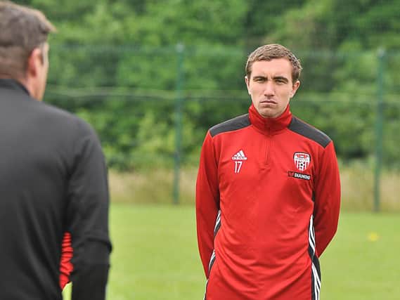 Derry City midfielder, Joe Thomson listens intensely to Derry City boss, Declan Devine during his first training session on Thursday.