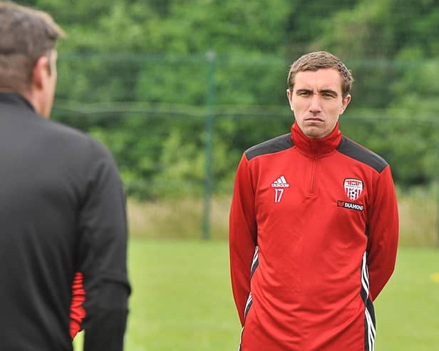 Derry City midfielder, Joe Thomson listens intensely to Derry City boss, Declan Devine during his first training session on Thursday.