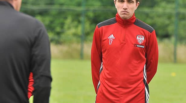 Derry City midfielder, Joe Thomson listens intensely to Derry City boss, Declan Devine during his first training session on Thursday.