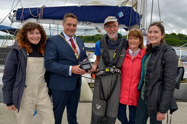 The Deputy Mayor of Derry and Strabane Alderman Graham Warke makes a presentation to Garry Crothers who completed an epic voyage across the Atlantic arriving in Derry on Saturday afternoon last.  Included in the photograph, from left are Gary’s daughter Oonagh, wife Marie and daughter Amy. DER2027GS - 032