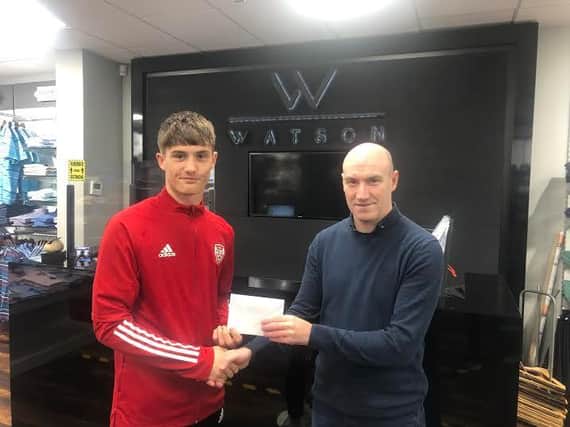 Derry City's Patrick Ferry receives the Watson Menswear Ulster Senior League Player of the Month award from Marty Fagan.