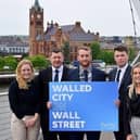Pictured at the Peace Bridge in Derry are (2nd left) Greg McCann, FinTrU Executive Director & North West Office Site Head with previous FinTrU NW Assured Skills Academy graduates, now FinTrU Analysts (l-r) Jenny Thompson, Damian Faulkner, CJ Martin and Megan Quigley.