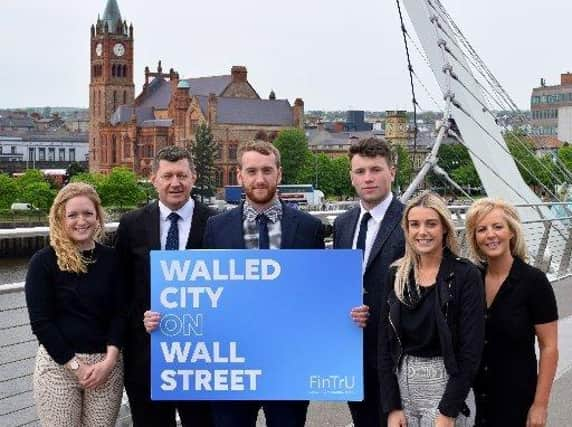 Pictured at the Peace Bridge in Derry are (2nd left) Greg McCann, FinTrU Executive Director & North West Office Site Head with previous FinTrU NW Assured Skills Academy graduates, now FinTrU Analysts (l-r) Jenny Thompson, Damian Faulkner, CJ Martin and Megan Quigley.