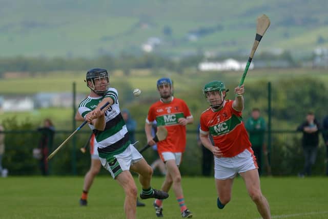 Na Maghas Padhraig Nelis gets off a shot under pressure from Laveys Chrissy Henry during the Senior Hurling Championship game held in Pirc Na Magha on Sunday afternoon last. DER2031GS - 005