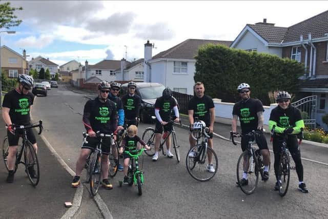 The group of cyclists raising money for Ardnashee School and College arrive at the home of Finn Harnett.