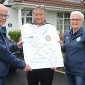 The missing ink...Jim 'Chang' Smith (centre) displayed the fully autographed Finn Harps 1974 FAI Cup winning replica jersey which goes on raffle this week with from left, Gerard McHugh and Harps shop staff member, Ann Kelly. Jim was the last name to be added to the jersey.
