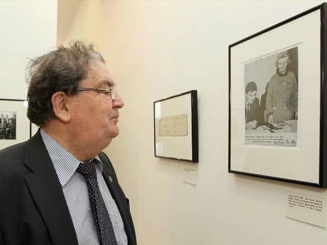 The late John Hume viewing a photograph of himself with fellow credit union pioneer Nora Herlihy in 1964.