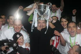 The late John Hume pictured holding the Airtricity League First Division trophy aloft after his beloved Derry City clinched the title in Monaghan in 2010.