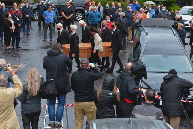A wicker coffin containing the remains of John Hume is carried past a large media presence into St Eugene’s Cathedral, by relatives, on Tuesday evening last. DER2032GS – 014