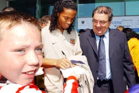 Brazilian Ronaldinho signs autographs for this excited young City fan as John Hume looks on proudly outside City of Derry airport.