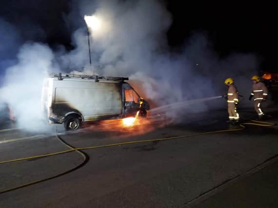 Firefighters deal with a burning van in Galliagh last night.