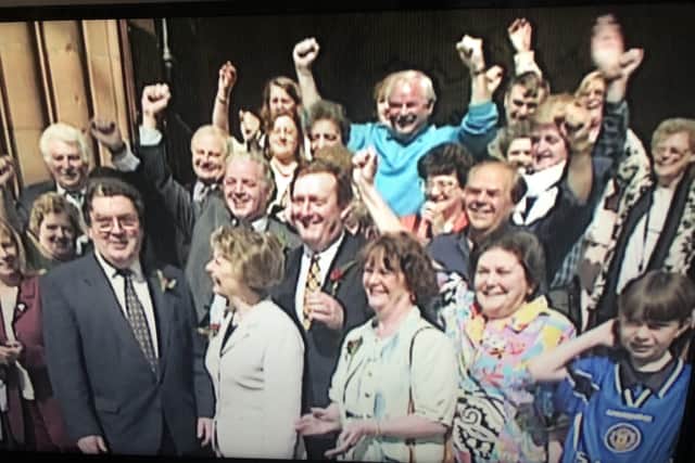 John Hume and SDLP party members and activists celebrating another election success outside the Guildhall in the mid 1990’s. I’m the young lad in the corner.