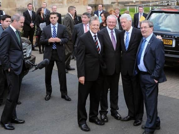 John Hume with Peter Robinson, Martin McGuinness and Bill Clinton at Magee College in 2010.