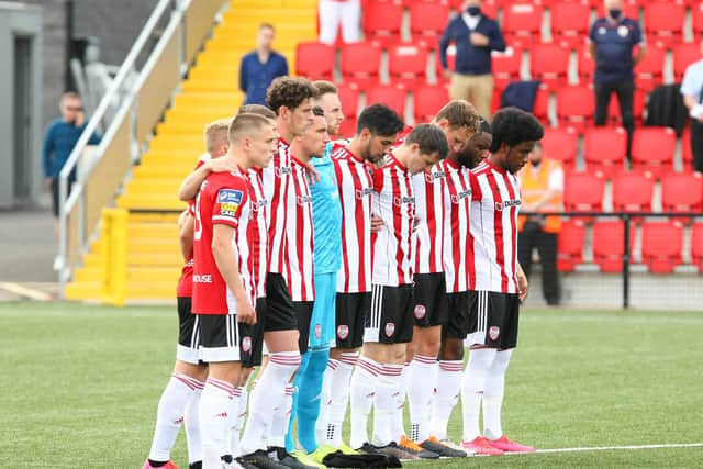 Derry City players observe a minute's silence in memory of the club's late president, John Hume.