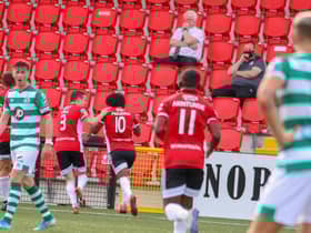 Goalscorer, Walter Figueria runs away to celebrate Derry's opener alongside Ciaran Coll.