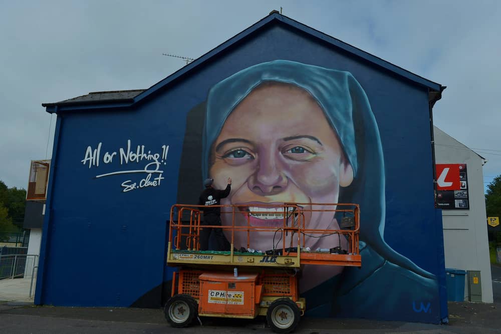 UV artist Ray Bonner working on a mural in honour of Sister Clare Crockett, on a gable wall in the Brandywell area, on Wednesday afternoon last. The mural will be unveiled at 6pm on Sunday evening next. DER2033GS - 005
