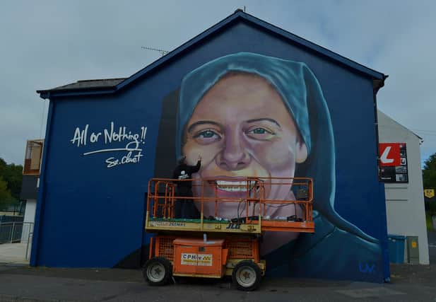 UV artist Ray Bonner working on a mural in honour of Sister Clare Crockett, on a gable wall in the Brandywell area, on Wednesday afternoon last. The mural will be unveiled at 6pm on Sunday evening next. DER2033GS - 005