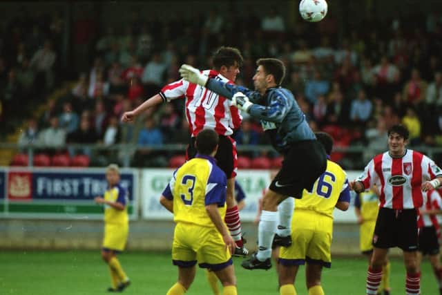 Derry Citys Gary Beckett beats the keeper to this ball but his header goes wide of the target.