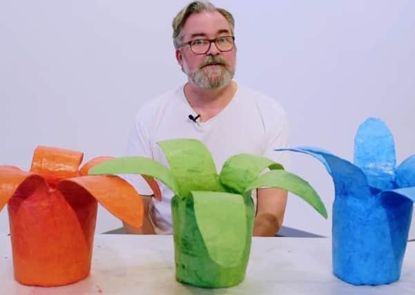 Artist Alan Whelan with some examples of the hyacinth flowers.