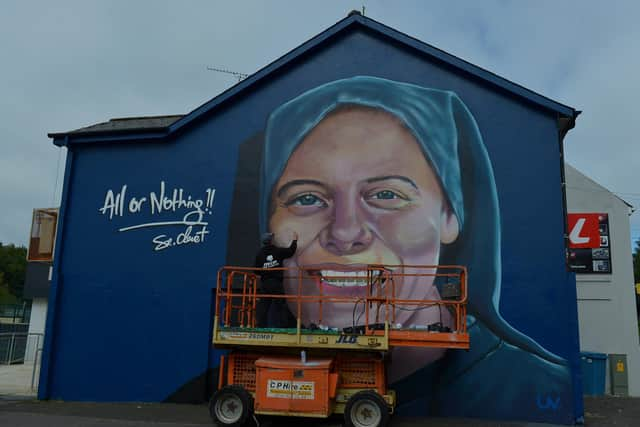 UV artist Ray Bonner working on a mural in honour of Sister Clare Crockett, on a gable wall in the Brandywell area, on Wednesday afternoon last. The mural will be unveiled at 6pm on Sunday evening next. DER2033GS - 005