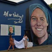 Shauna Gill, on the left, and Megan Nicell unveil  a prayer card at the a mural dedicated to the  memory of their sister Sr. Clare Crockett , on Sunday evening last. DER2034GS - 008