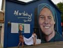 Shauna Gill, on the left, and Megan Nicell unveil  a prayer card at the a mural dedicated to the  memory of their sister Sr. Clare Crockett , on Sunday evening last. DER2034GS - 008