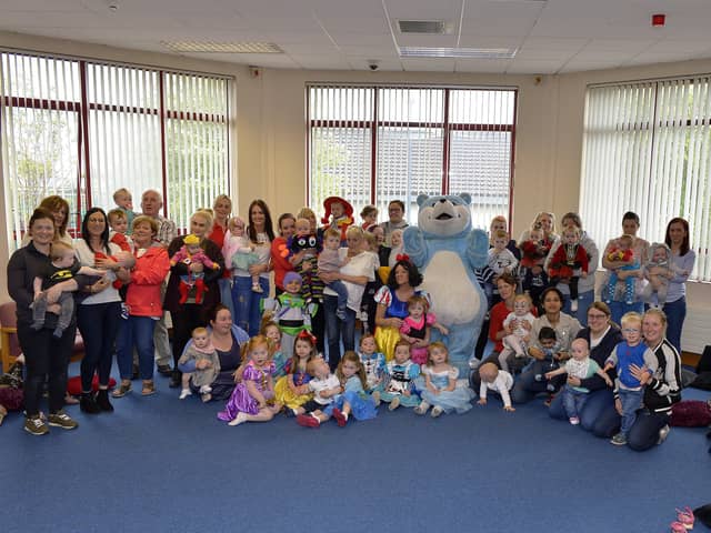 THE WAY WE WERE... 2018: The Book Start Bear pictured with children, mums, grandparents and Surestart staff at a Surestart Edenballymore Book Start event held in Creggan Library. DER2418GS058