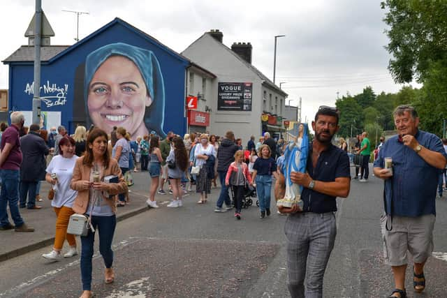 Michael Doherty carries a statue of the Blessed Virgin Mary to Our Lady of Lourdes Grotto, Brandywell, for a candle light Rosary and Mass for the late Sr. Clare Crockett, on Sunday evening last. DER2034GS - 010