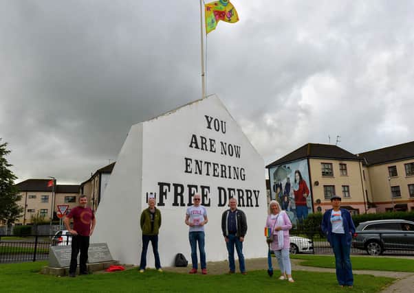Pictured at the launch of the Foyle Pride 2020 Festival ‘Sign of the Times’ flag at Free Derry Wall, on Saturday afternoon last, are Paul Gillespie, Shá Gillespie, Foyle Pride committee member, Jim Doherty, Chairperson, Martin McConnellogue, committee member, Christina Robson and Dalila. The flag was designed by Caroline Devenney and funded by DCSDC. DER2034GS - 038