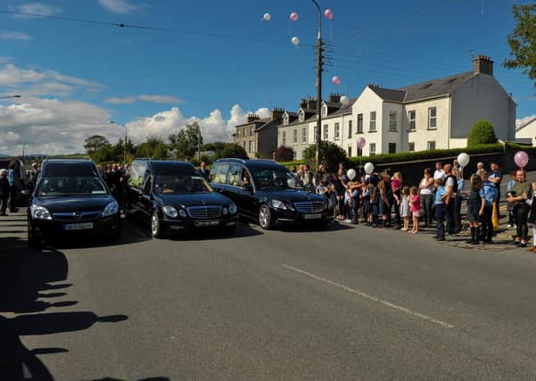 Pupils from Scoil Eoghan release white balloons at the funeral of John Mullan and his children Tomás (14) and Amelia (6) at St Pius X Church in Moville yesterday.  DER2035GS – 012