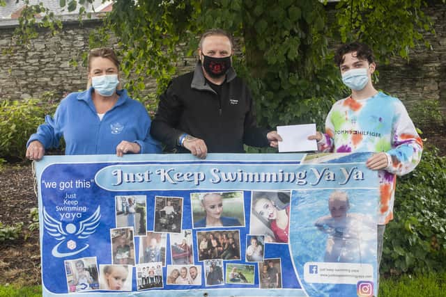 Andre and Karen Johnston receiving a cheque in aid of 'Just Keep Swimming YaYa' from local YouTuber Adam McIntyre