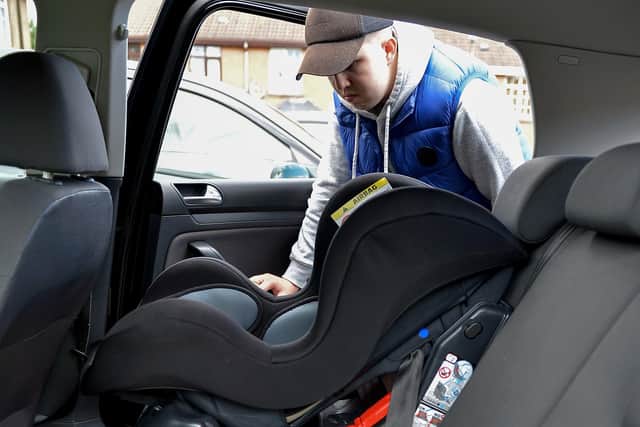 Scott Rice examines the glass showered rear seats and baby seat in his car in O’Casey Court, Ballymagroarty, which was damaged by youths in the early hours of Friday morning.  DER2036GS – 012