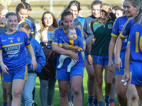 Steelstown’ s Emma Doherty celebrates with her four month old daughter, Cara, after winning the Derry Ladies Senior Football Championship Final in Celtic Park on Sunday. (DER2038GS)